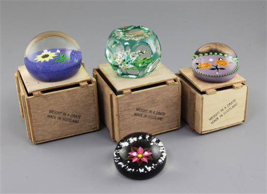 Four William Manson Senior glass paperweights; three with crates